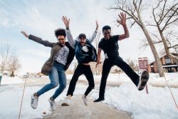 Three happy young people jumping in the air